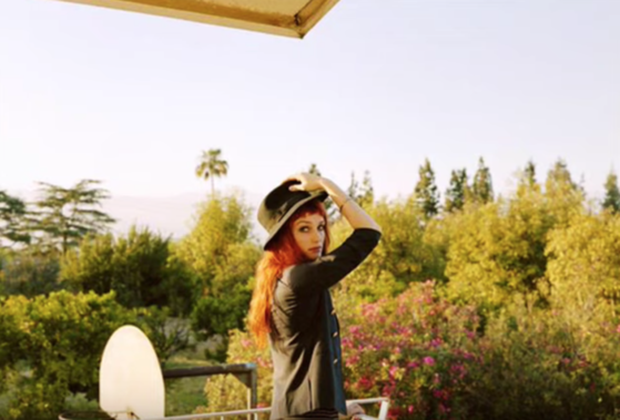 Alison Sudol outside wearing a hat